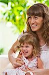 portrait of happy mother with daughter  having good time in summer environment