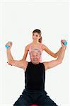 senior man and young woman exercising in gym. Copy space