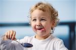 Portrait of the little boy eating yogurt