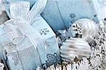 Wrapped gift boxes with silver Christmas ornaments