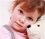 Portrait of sad little girl with teddy