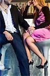 young couple sitting on bar stools and holding hands