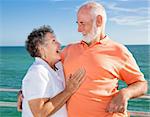 Beautiful senior couple laughing and flirting on vacation.