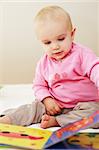 Portrait of cute baby reading a picture book