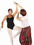 Young caucasian ballerina girl on white background and reflective white floor showing various ballet steps and positions, being corrected by teacher. Not Isolated.