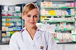portrait of mid adult pharmacist looking at camera