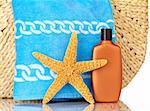 Straw Beach Bag, Blue Towel, Sunscreen With Water Drops and Starfish Isolated On White