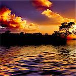 Orange And Blue Sunset Reflecting In Water On Beach