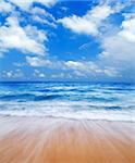 Summertime at beautiful blue beach with waves.