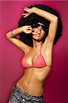 Beautiful woman with huge afro haircut on pink