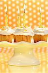 Cupcakes with orange zest sprinkled on top with polka dot background