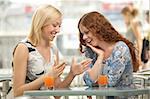 Two young women are cheered in a cafe