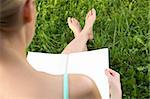 A girl sitting on the grass with a book