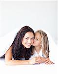 Daughter Kissing her mother on bed