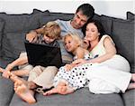 Young Family on a sofa with laptop