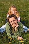 Woman and little girl on the spring meadow