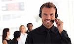 Young Businessman with headset on in office environment