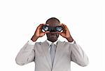 Young African business man looking through binoculars