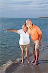 Retired senior couple on vacations taking in the sights at the beach.