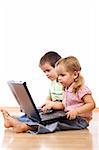 Kids sitting on the floor, concentrated using laptops - isolated