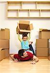Moving to a new home is fun - kid and father having good times with lots of cardboard boxes