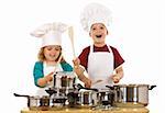 Happy kids dressed as chefs making noise with the cooking pots and wooden spoons - isolated