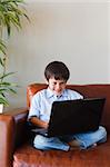 Kid using his laptop at home