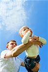 Baby boy flying on his father's hands