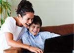 Happy mother and son having fun with a laptop