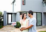 Happy young couple after buying house