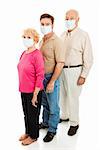 Elderly couple and their adult son wearing surgical masks to protect against a health epidemic.  Could be swine flu.