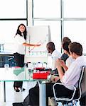 Confident attractive businesswoman smiling in a presentation