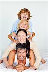 Family having fun in bed looking at the camera