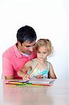 Father and daughter drawing together at home