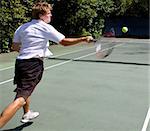 Tennis Player smashing a ball across court