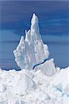 Beautifull and wired iceberg sculpture on deep blue sky