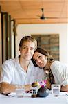 A young couple sitting together in a restaurant