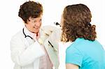 Friendly female doctor uses an otoscope to examine a teenage girl.   Isolated on white.