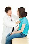 Female doctor examining a teenage girl, listening to her heartbeat with a stethoscope.  Isolated.