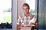 Portrait of Male Student reading text book