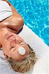 Woman at a spa with white stone on her forehead