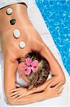 Woman at a spa with white stone on her forehead