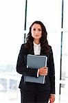 Attractive young businesswoman working in office