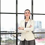 Beautiful confident young businesswoman with folded arms