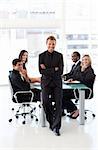 Young confident businessman with folded arms in a presentation