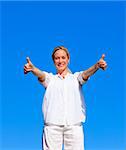 Young woman doing exercises outdoors with thumbs up