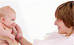 Woman playing with her newborn baby in hospital