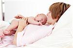 Woman holding her newborn baby in hospital