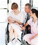 Patient with her newborn baby and doctors in hospital