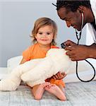Children's doctor exams a little girl with stethoscope in a hospital